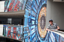 Marcus posing with the CMS poster in Building 40. Photo: Michael Hoch